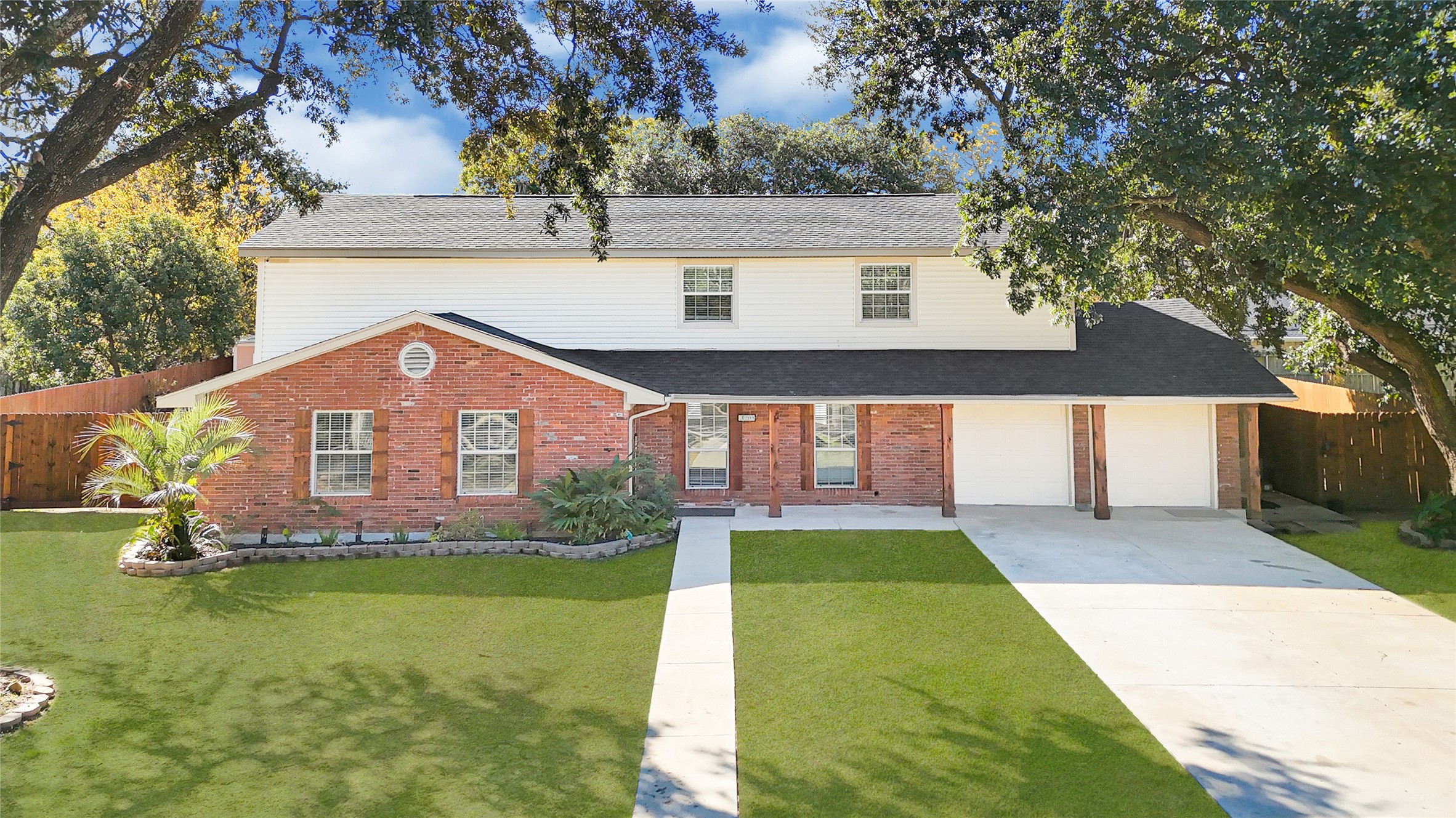 5007 Inverness Drive Baytown, TX 77521 - Photo 1 of 41 a front view of a house with a yard table and chairs