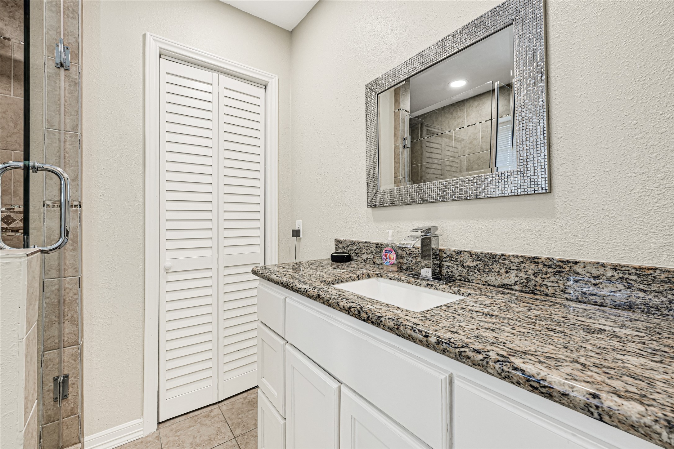 5007 Inverness Drive Baytown, TX 77521 - Photo 12 of 41 a bathroom with a granite countertop sink and a mirror