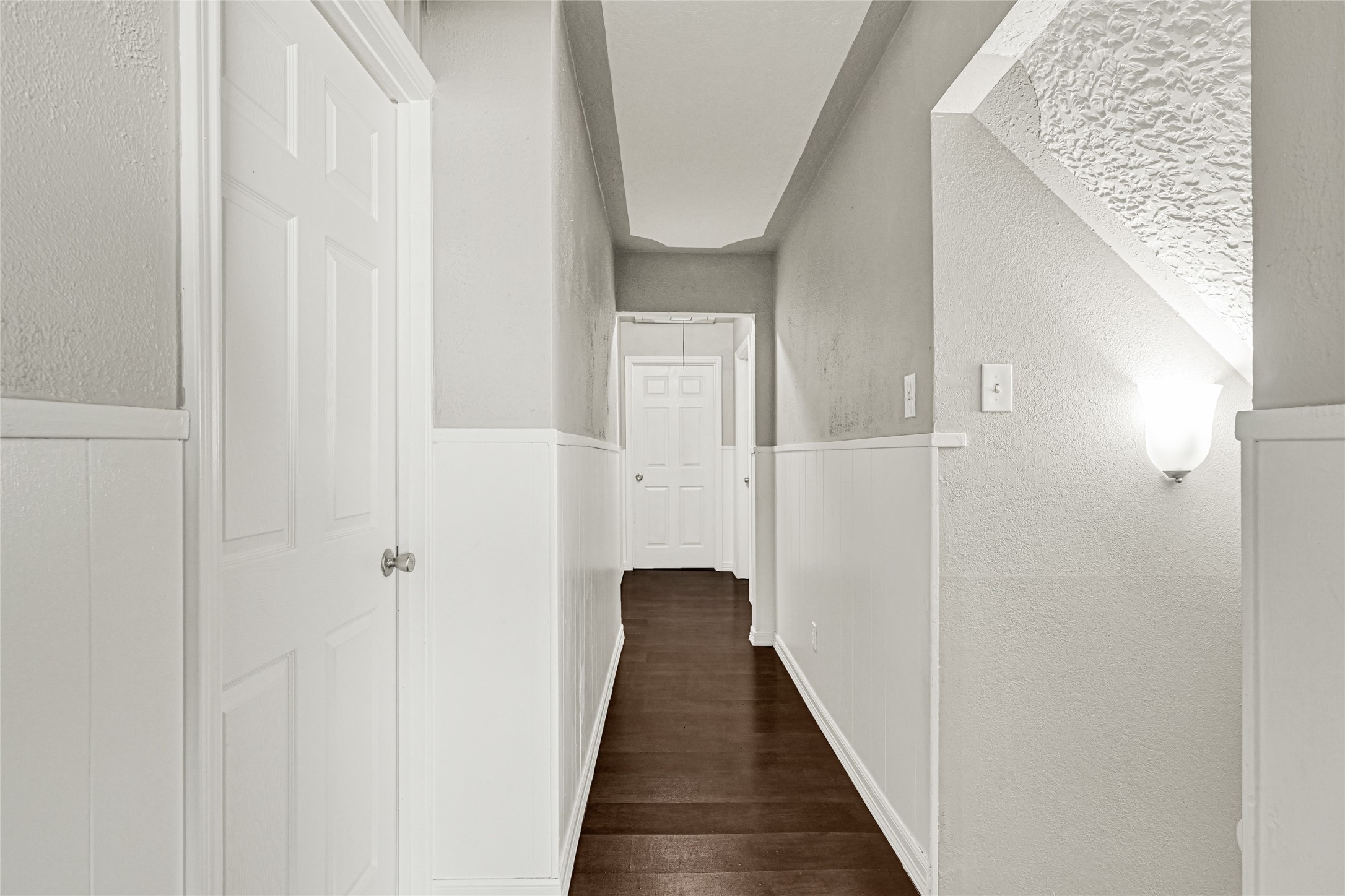 5007 Inverness Drive Baytown, TX 77521 - Photo 16 of 41 a view of a hallway with wooden floor and staircase