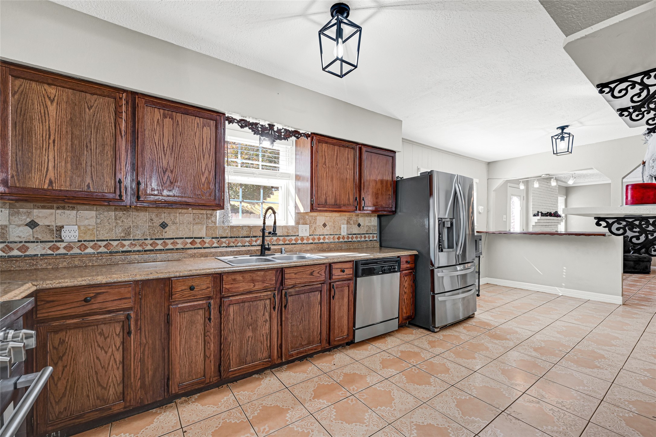 5007 Inverness Drive Baytown, TX 77521 - Photo 24 of 41 a kitchen with stainless steel appliances granite countertop a stove top oven a sink dishwasher and a refrigerator