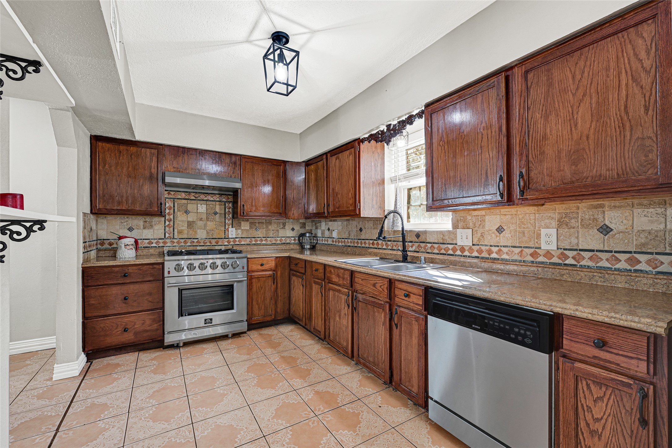 5007 Inverness Drive Baytown, TX 77521 - Photo 25 of 41 a kitchen with stainless steel appliances granite countertop a stove sink microwave and cabinets