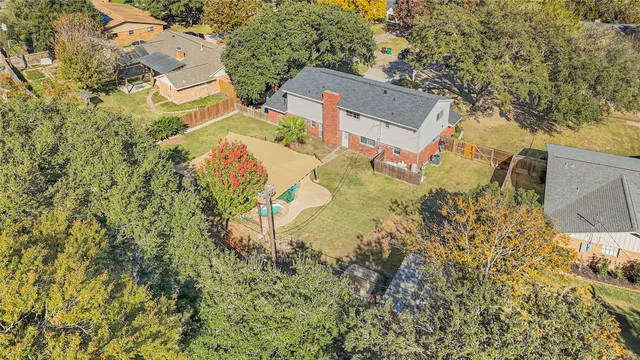 an aerial view of a house with a yard