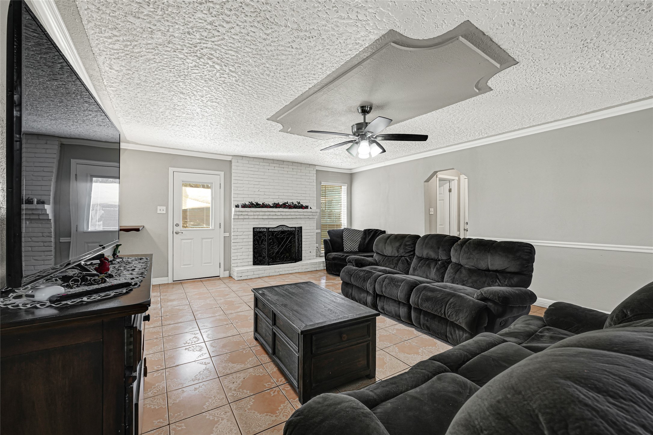 5007 Inverness Drive Baytown, TX 77521 - Photo 8 of 41 a living room with furniture and a fireplace