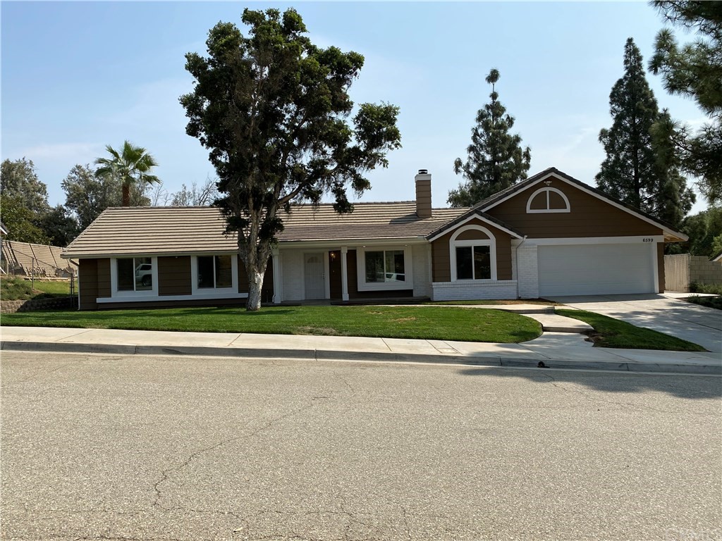 6599 Country Lane Riverside, CA 92505 - Photo 1 of 1 a front view of a house with a yard