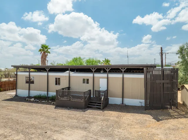 a view of a chair and table in the backyard