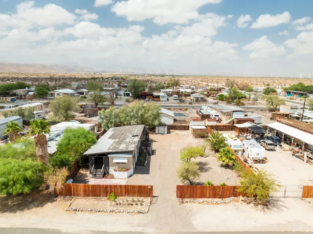 an aerial view of residential houses with outdoor space