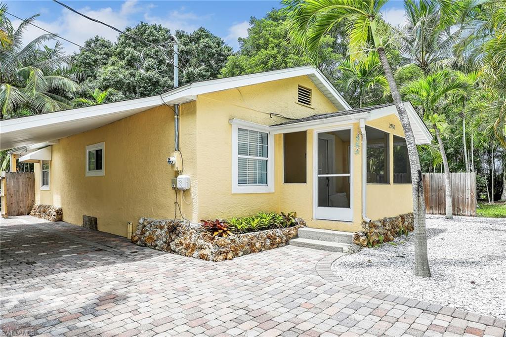 2780 Weeks Avenue Naples, FL 34112 - Photo 28 of 34 a front view of a house with a yard