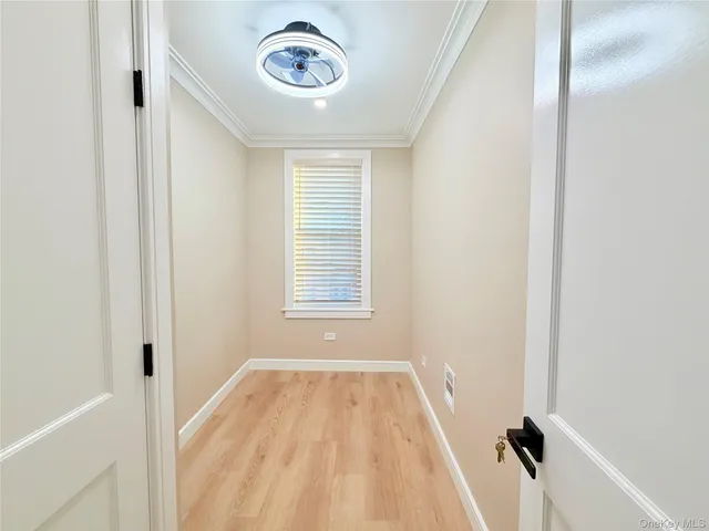 a view of a room with a window and a ceiling fan