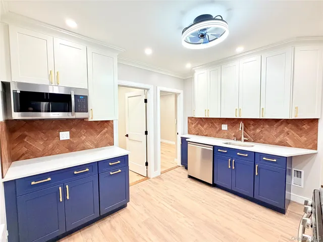 a large kitchen with stainless steel appliances granite countertop a sink and a stove