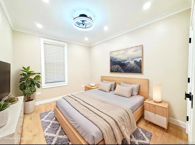 a bedroom with a large bed and a potted plant