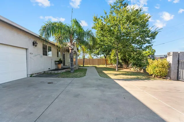 a view of a dining room with furniture and a chandelier