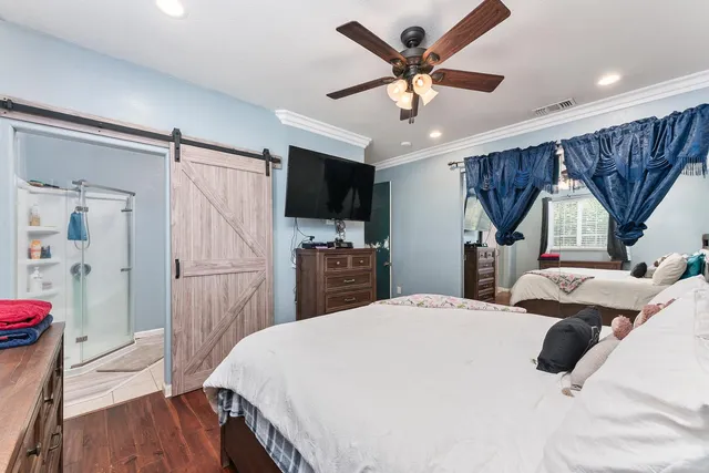 a kitchen with white cabinets and window