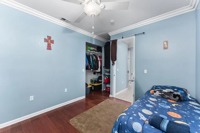 a room with pool table and wooden floor
