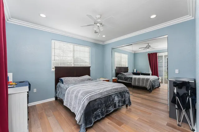 a living room with furniture a flat screen tv and a large window
