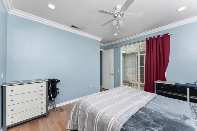 a bedroom with furniture and a wooden floor
