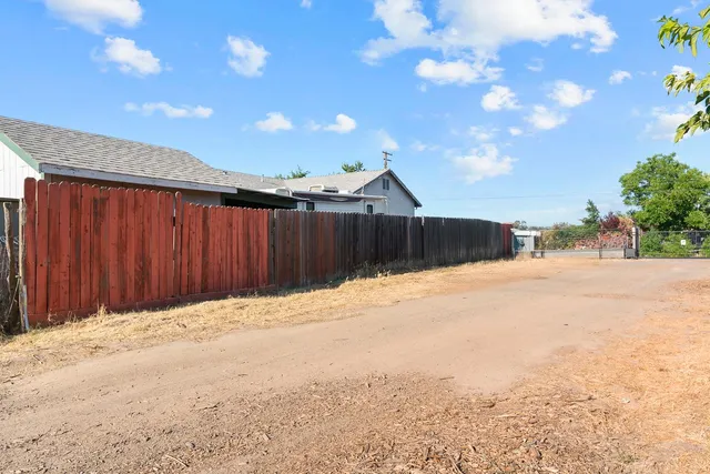 a white house that has a tree in front of it