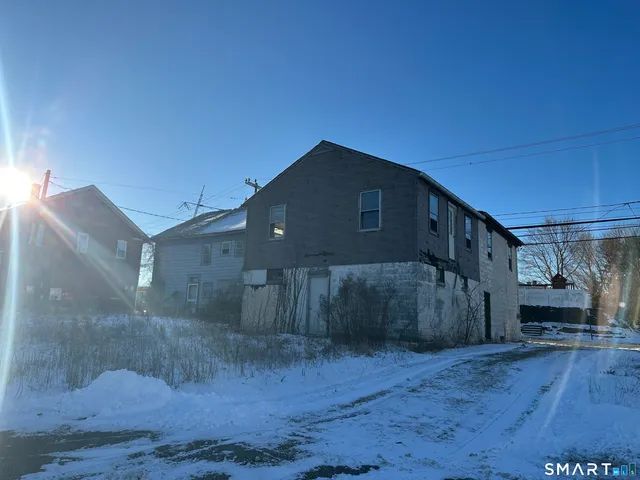 a view of a house with wooden fence