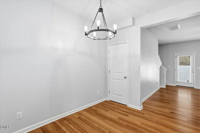 a view of a room with wooden floor