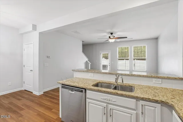 a kitchen with sink cabinets and chandelier