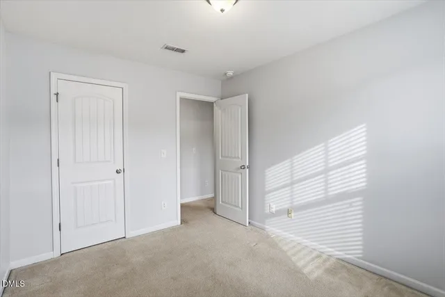 a view of a room with closet and windows