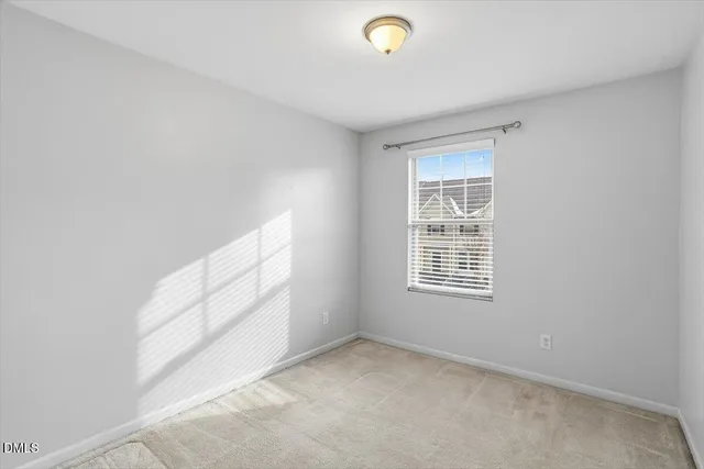 a view of a livingroom with an empty space and a window