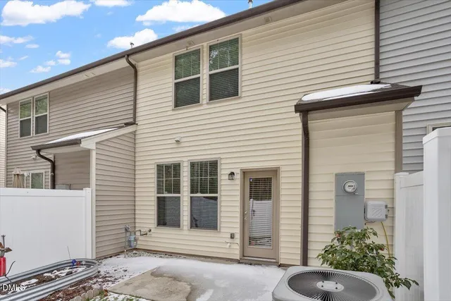 a view of a house with a chairs in patio