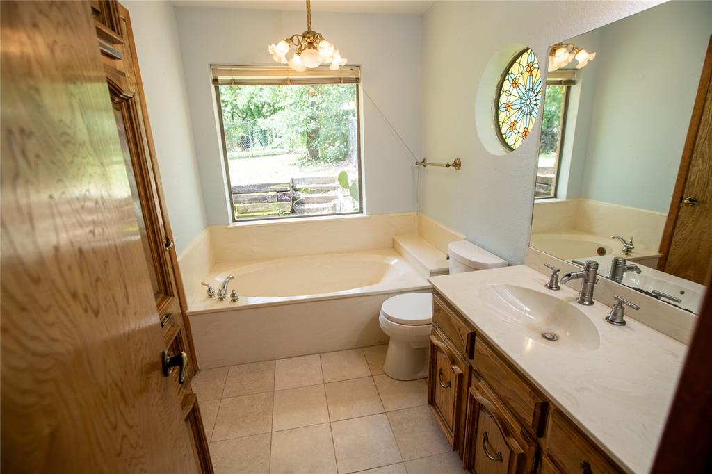 6837 Roberts Lane Fort Worth, TX 76140 - Photo 16 of 39 a bathroom with a sink a toilet and a bathtub