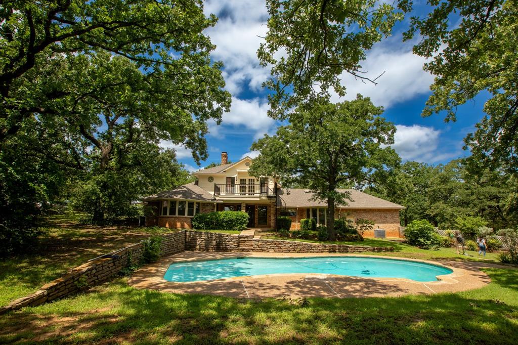 6837 Roberts Lane Fort Worth, TX 76140 - Photo 2 of 39 a view of a house with a big yard and large trees