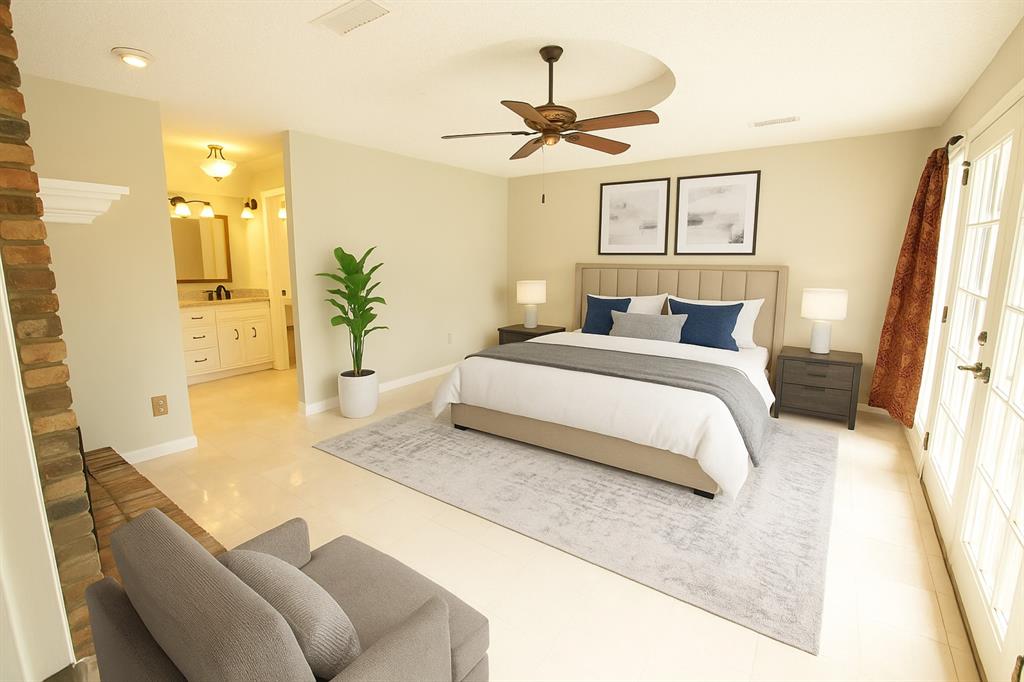 6837 Roberts Lane Fort Worth, TX 76140 - Photo 23 of 39 a spacious bedroom with a bed a couch and a chandelier