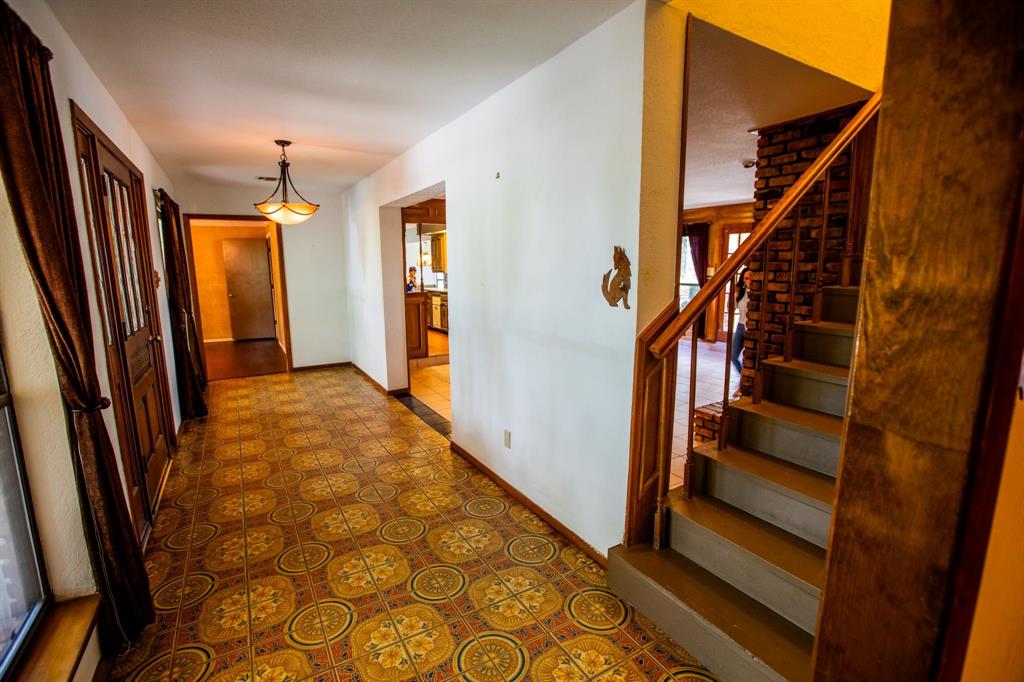 6837 Roberts Lane Fort Worth, TX 76140 - Photo 35 of 39 a view of entryway with stairs and wooden floor