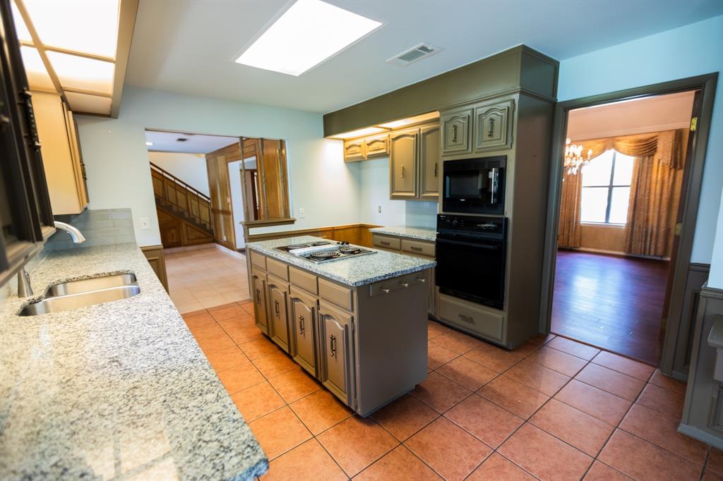 6837 Roberts Lane Fort Worth, TX 76140 - Photo 9 of 39 a kitchen with stainless steel appliances granite countertop a stove a sink and a refrigerator