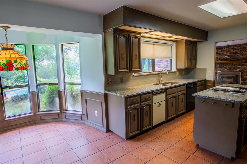 6837 Roberts Lane Fort Worth, TX 76140 - Photo 10 of 39 a kitchen with stainless steel appliances granite countertop a stove a sink and a microwave