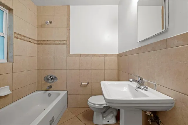 a bathroom with a sink a toilet and bathtub