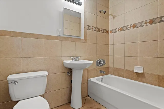 a bathroom with a sink a toilet and bathtub