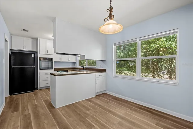 a kitchen with a refrigerator and a stove