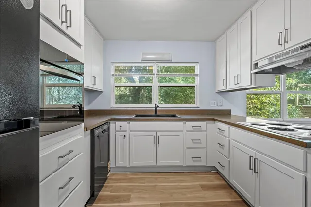 a kitchen with a sink stove and cabinets