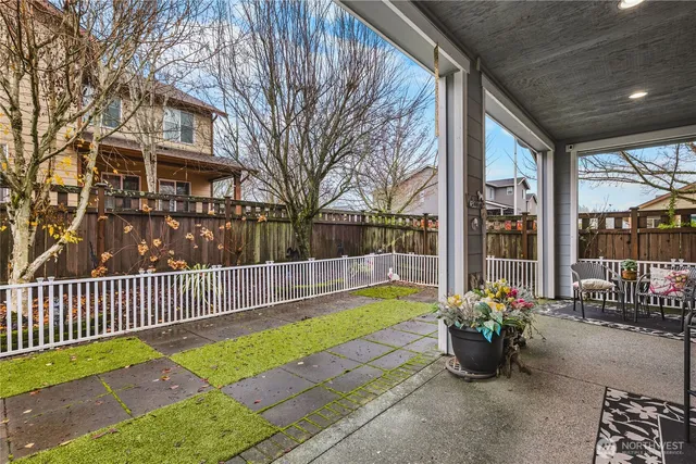 a view of a patio with table and chairs near a barn