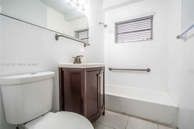 a bathroom with a sink a toilet and bathtub