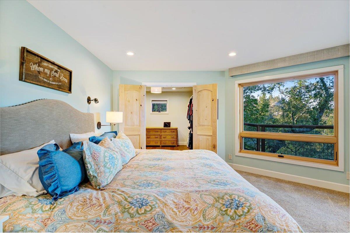 7409 Hihn Road Ben Lomond, CA 95005 - Photo 39 of 101 a large bedroom with a bed and large windows