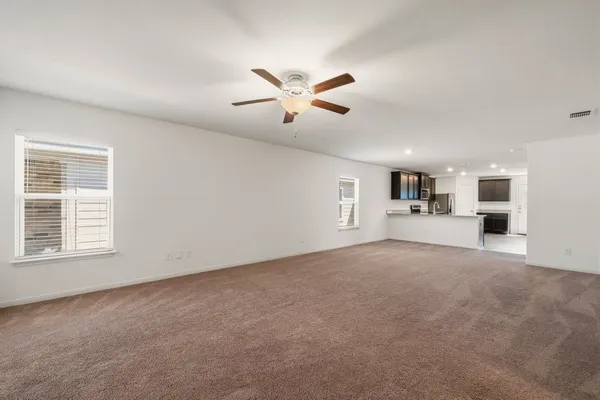 a view of a livingroom with a ceiling fan and window