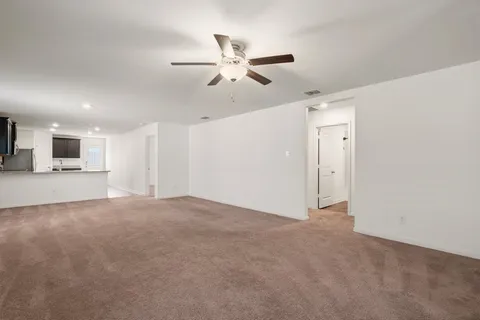 a view of a livingroom with a ceiling fan and window