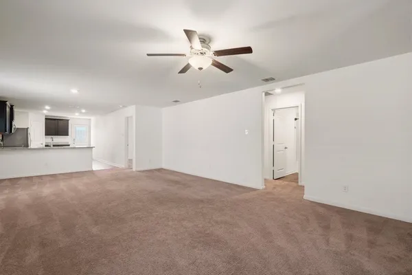 a view of a livingroom with a ceiling fan and window