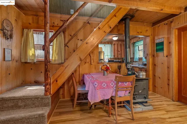 a dining room with furniture and wooden floor