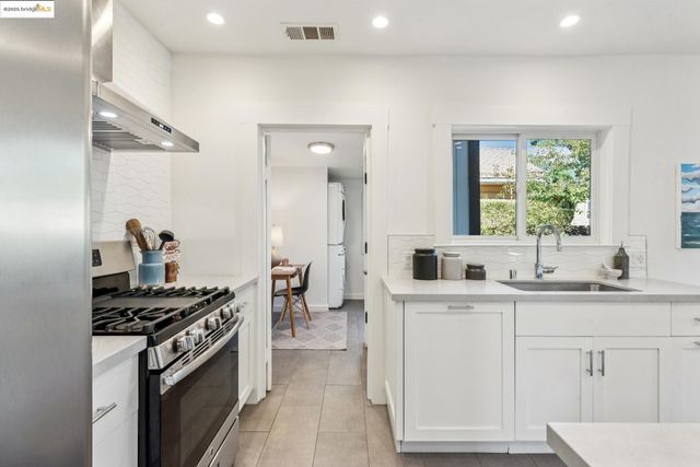 a kitchen with a sink stove and cabinets