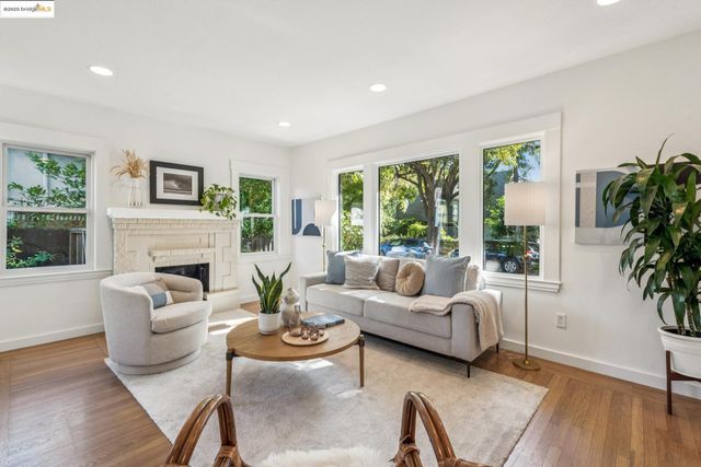 a living room with furniture fireplace and a large window