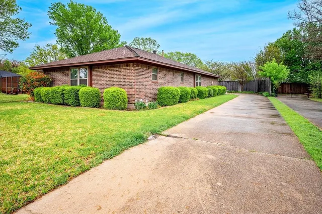 a view of a house with yard and a garden