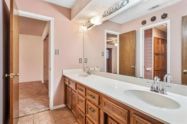 a bathroom with a sink double vanity and a mirror