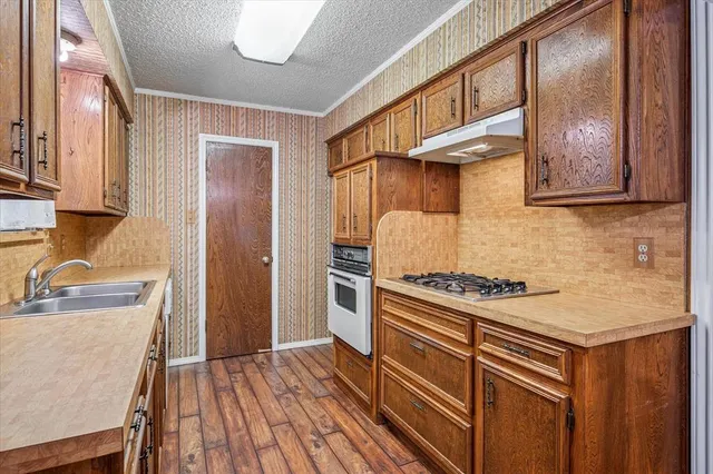 a kitchen with wooden cabinets and a stove top oven