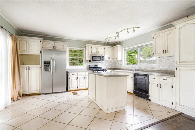 a kitchen with stainless steel appliances granite countertop a refrigerator sink and cabinets