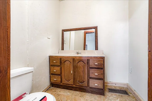a bathroom with a sink a toilet and a mirror